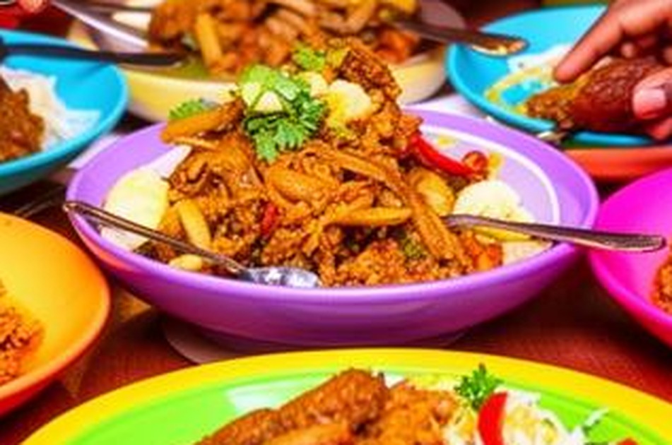 A bowl of pasta with chicken and peppers, garnished with coriander