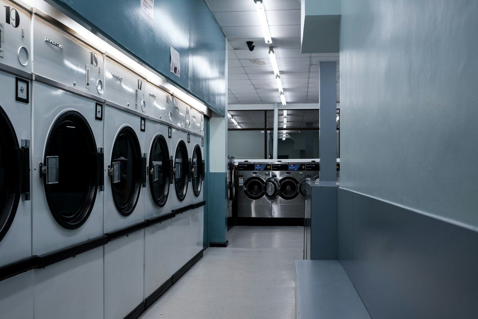 A row of washing machines in a laundromat